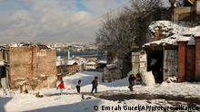 People walk in the snow at Istanbul, Monday, Jan. 24, 2022. Snow blanketed most of Turkey's largest city Monday. Flurries are forecast to continue over the next few days in Istanbul, a metropolis of some 16 million spanning two continents and bridging Europe to Asia. (AP Photo/Emrah Gurel)