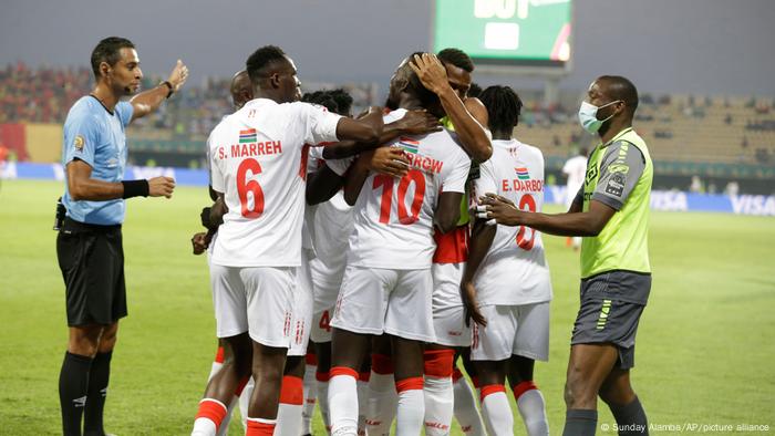 Gambia's Musa Barrow celebrates with teammates after scoring