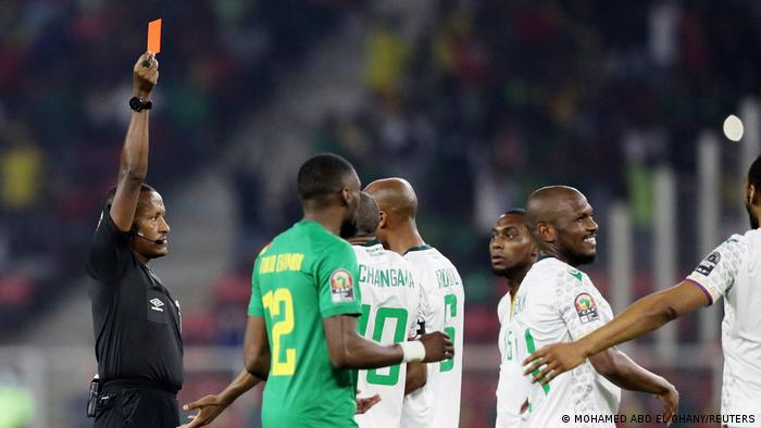Comoros' Nadjim Abdou is shown a red card by referee Bamlak Tessema