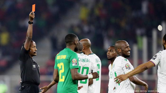 Comoros' Nadjim Abdou is shown a red card by referee Bamlak Tessema