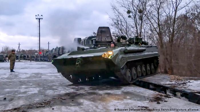 A Russian armored vehicle drives off a platform after its arrival in Belarus.