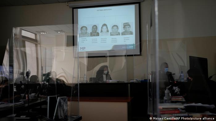 Photos of victims of human rights violations during Guatemala's civil war are projected in court