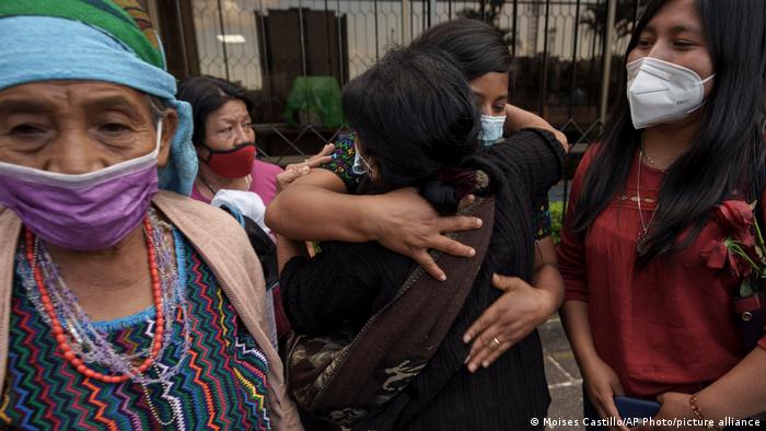 Women identified as victims of human rights violations during Guatemala's civil war, embrace outside the Supreme Court in Guatemala City, Monday