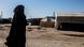 A fully veiled woman walks in Syria's Kurdish-run al Hol camp, where many relatives of suspected "IS" fighters live A fully veiled woman walks in Syria's Kurdish-run al Hol camp, where many relatives of suspected "IS" fighters live