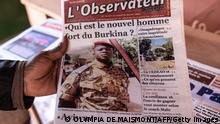 A man buys a newspaper with theh the picture of Paul-Henri Sandaogo Damiba the leader of the mutiny and of the Patriotic Movement for the Protection and the Restauration (MPSR) in Ouagadougou on January 25, 2022. - In the aftermath of the coup d'etat in Burkina Faso which overthrew President Roch Marc Christian Kaboré, a demonstration in support of the putschists is scheduled for Tuesday in Ouagadougou where calm has returned after days of tension. (Photo by OLYMPIA DE MAISMONT / AFP) (Photo by OLYMPIA DE MAISMONT/AFP via Getty Images)