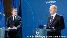 German Chancellor Olaf Scholz, right, and French President Emmanuel Macron hold a joint press conference before their talks in Berlin, Tuesday, Jan. 25, 2022. (Kay Nietfeld/Pool Photo via AP)