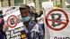 Protesters hold placards against the Bitcoin law during a protest in El Salvador Protesters hold placards against the Bitcoin law during a protest in El Salvador