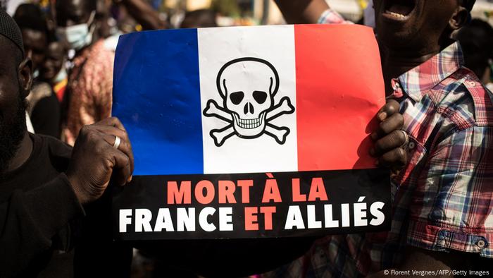 Sign held up at a protest in Mali reading: Death to France and its allies