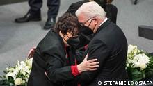 German President Frank-Walter Steinmeier hugs holocaust survivor Inge Auerbacher under the eyes of the President of the Bundestag (lower house of parliament) Baerbel Bas (behind) during the annual ceremony in memory of Holocaust victims and survivors in the plenary of the Bundestag on January 27, 2022, the International Holocaust Remembrance Day. (Photo by Stefanie LOOS / AFP)