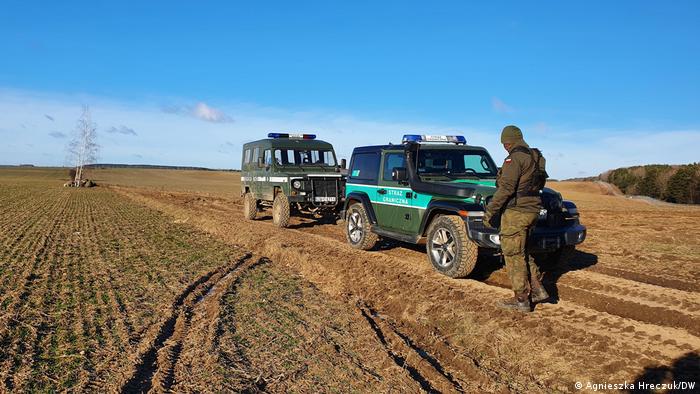 Jeeps with border guard in a field
