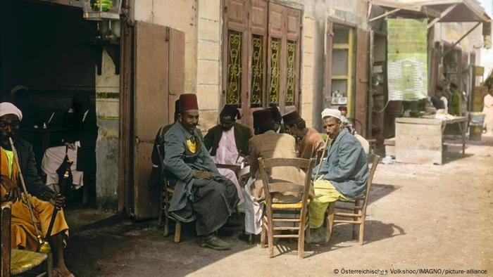 Egyptian men smoke waterpipes with hashish, in around 1910.