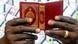 A photograph of a man's hands holding the Quran A photograph of a man's hands holding the Quran