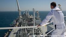 An employee stands on the Expedient regasification ship, anchored off the coast of Israel in the Mediterranean Sea on February 26, 2015, as natural gas began flowing from the vessel, hired by the Israel Electric Corporation, to its power stations. The ship, anchored about ten kilometres from the Hadera coast, was connected the previous week to the marine buoy and as of February 25, natural gas has begun flowing from the LNG (liquid natural gas) ship through an underwater pipeline directly to the company's power stations throughout the country. AFP PHOTO / MENAHEM KAHANA (Photo credit should read MENAHEM KAHANA/AFP via Getty Images)