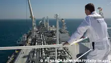 An employee stands on the Expedient regasification ship, anchored off the coast of Israel in the Mediterranean Sea on February 26, 2015, as natural gas began flowing from the vessel, hired by the Israel Electric Corporation, to its power stations. The ship, anchored about ten kilometres from the Hadera coast, was connected the previous week to the marine buoy and as of February 25, natural gas has begun flowing from the LNG (liquid natural gas) ship through an underwater pipeline directly to the company's power stations throughout the country. AFP PHOTO / MENAHEM KAHANA (Photo credit should read MENAHEM KAHANA/AFP via Getty Images)