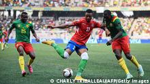 Gambia's forward Muhammed Badamosi (C) is challenged by Cameroon's defender Nouhou Tolo (L) and Cameroon's defender Michael Ngadeu-Ngadjui during the Africa Cup of Nations (CAN) 2021 quarter final football match between Gambia and Cameroon at the Japoma Stadium in Douala on January 29, 2022. (Photo by CHARLY TRIBALLEAU / AFP) (Photo by CHARLY TRIBALLEAU/AFP via Getty Images)