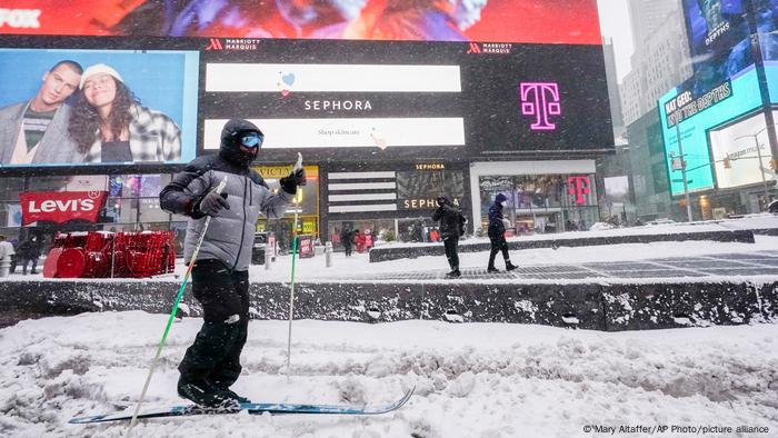 A person cross country skis through New York's Times Square during a snow storm.