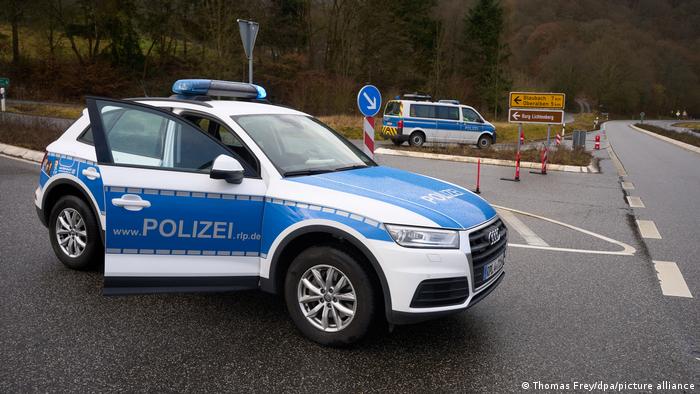 Police vehicles block a rural road in western Germany, where two officers were shot dead during a routine traffic stop. January 31, 2022, near Kusel, Rhineland Palatinate.