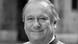 Rolf Zehetbauer in a blck-and-white image smiling into the camera. Rolf Zehetbauer in a blck-and-white image smiling into the camera.