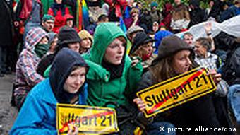 People in anoraks carrying anti-Stuttgart 21 signs