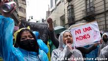 Demonstrators shout slogans as they march against gender violence, particularly against women's disappearances and femicide in La Paz, Bolivia, Monday, Jan. 31, 2022. The sign reads in Spanish Not one less. (AP Photo/Juan Karita)