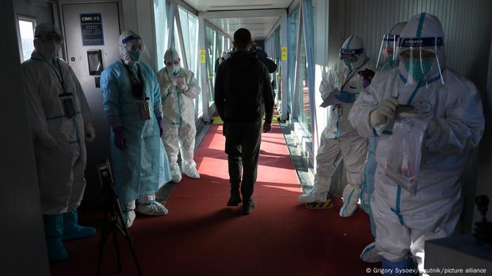Mitarbeiter des Testzentrums am Flughafen von Peking in Schutzanzügen