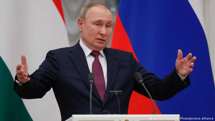 Russian President Vladimir Putin gestures while speaking to the media during a joint news conference with Hungary's Prime Minister Viktor Orban