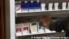 A shopkeeper packs well-known brands of cigarettes in his shop, as cigarettes are unbanned, in Athlone, Cape Town, on August 18, 2020 in Cape Town. - South Africa moved into level two of a five-tier lockdown on August 18, 2020, to continue efforts to curb the spread of the COVID-19 coronavirus. Under level two liquor and tobacco sales will resume. (Photo by RODGER BOSCH / AFP) (Photo by RODGER BOSCH/AFP via Getty Images)