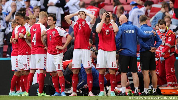 Denmark's players encircle their teammate Christian Eriksen in a now iconic image.