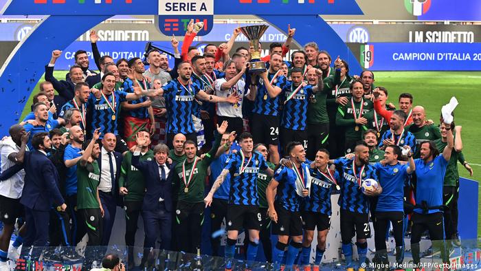 Surrounded by his teammates, Christian Eriksen lifts the Scudetto Trophy with Inter Milan last season.