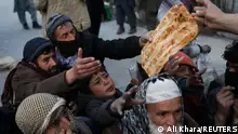 People reach out to receive bread, in Kabul, Afghanistan, January 31, 2022. REUTERS/Ali Khara
+++ Afghan bakery donates bread as millions suffer extreme hunger