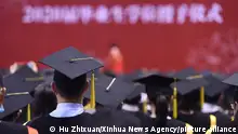 (210704) -- BEIJING, July 4, 2021 (Xinhua) -- Graduates of 2020 attend the commencement ceremony of Renmin University of China in Beijing, capital of China, July 4, 2021. Renmin University of China held a commencement ceremony for the graduates of 2020 on Sunday. Last year, in order to reduce the risk of infection of COVID-19, only a minority of graduates attended the ceremony on site with the others attending online. (Xinhua/Hu Zhixuan)