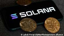 Solana logo displayed on a phone screen and representation of cryptocurrencies are seen in this illustration photo taken in Krakow, Poland on August 21, 2021. (Photo Illustration by Jakub Porzycki/NurPhoto)