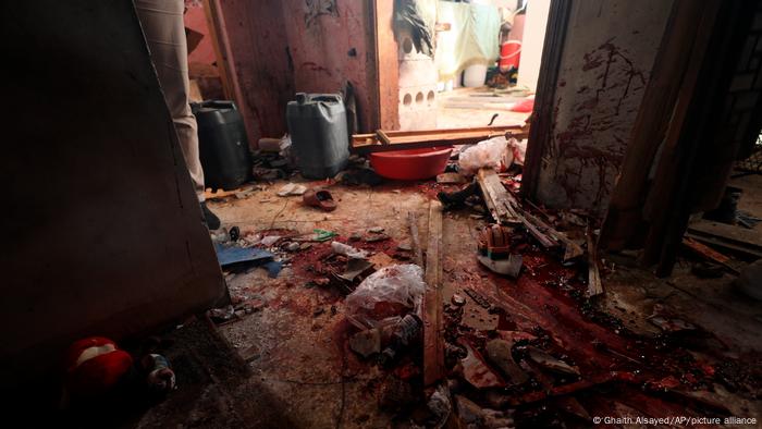 Blood covers the floor of a destroyed house after an operation by the US military in the Syrian village of Atmeh in Idlib