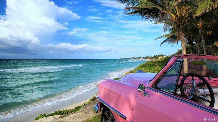 A pink classic car on the coast of Varadero in Cuba.