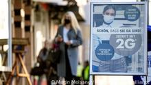 FILE - A sign in front of a shop in Gelsenkirchen, Germany, reads: Nice, that you are here - entrance only with 2G, meaning only people who are vaccinated or recovered from the coronavirus are allowed to enter, on Jan. 10, 2022. The risk of recession is looming for Germany after Europe’s biggest economy shrank at the end of 2021 and as it faces a bumpy start to this year. The rapid spread of COVID-19's omicron variant is deterring people from shopping and travel and supply bottlenecks are holding back manufacturers. The state statistics agency said Friday, Jan. 14, 2022 that output in Germany fell by between 0.5% and 1% in the fourth quarter. (AP Photo/Martin Meissner, File)