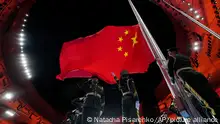 The Chinese national flag is raised during the opening ceremony of the 2022 Winter Olympics, Friday, Feb. 4, 2022, in Beijing. (AP Photo/Natacha Pisarenko)