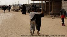 Boys from Islamic State-held areas walk together in the marketplace at Al-Hol camp, Hassakeh province, Syria, Sunday, March 31, 2019. (AP Photo/Maya Alleruzzo)