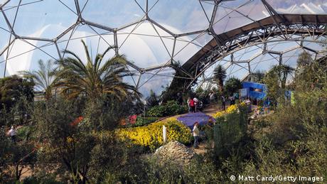 England I Visitors among flowers and plants in a greenhouse of the Eden Project