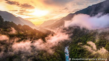 Mist forms over the Tara Gorge in Montenegro at sunset.