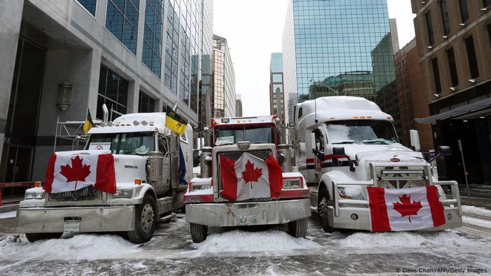 Trucks with Canadian flags at the front in the snow