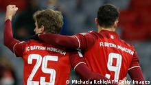 Bayern Munich's German forward Thomas Mueller (2nd R) celebrates scoring the opening goal with his teammate Bayern Munich's Polish forward Robert Lewandowski (R) during the German first division Bundesliga football match between FC Bayern Munich and RB Leipzig in Munich, southern Germany on February, 5, 2022. - DFL REGULATIONS PROHIBIT ANY USE OF PHOTOGRAPHS AS IMAGE SEQUENCES AND/OR QUASI-VIDEO ALTERNATIVE CROP (Photo by MICHAELA REHLE / AFP) / DFL REGULATIONS PROHIBIT ANY USE OF PHOTOGRAPHS AS IMAGE SEQUENCES AND/OR QUASI-VIDEO ALTERNATIVE CROP (Photo by MICHAELA REHLE/AFP via Getty Images)
