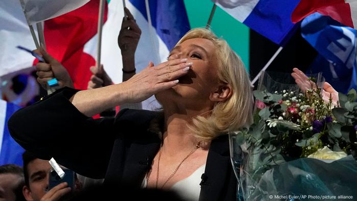 Marine Le Pen blows kiss to audience after giving a speech at a campaign rally in Reims
