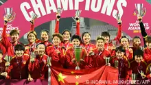 China's players celebrate with the trophy after their win in the AFC Women's Asian Cup India 2022 football final match between China and South Korea in Navi Mumbai on February 6, 2022. (Photo by INDRANIL MUKHERJEE / AFP)