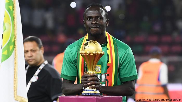 Senegal's forward Sadio Mane holds the AFCON trophy 