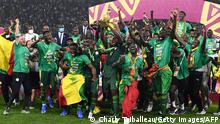 Senegal's players celebrate with the trophy after winning the Africa Cup of Nations (CAN) 2021 final football match between Senegal and Egypt at Stade d'Olembe in Yaounde on February 6, 2022. (Photo by CHARLY TRIBALLEAU / AFP) (Photo by CHARLY TRIBALLEAU/AFP via Getty Images)