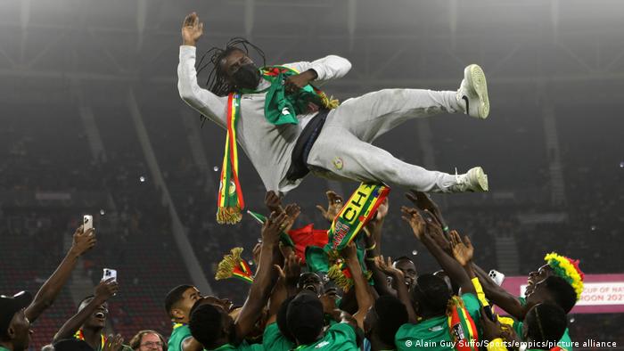 Senegal players throw head coach and former captain Aliou Cisse into the air following their victory