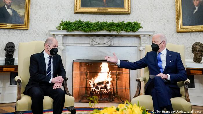President Joe Biden gestures during a meeting with German Chancellor Olaf Scholz in the Oval Office of the White House, Monday, Feb. 7, 2022, in Washington. 