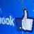 The logo of the social network Facebook on a broken screen of a mobile phone