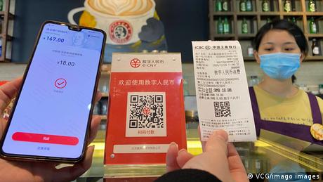 A signage of the central bank-backed digital yuan is seen at a coffee shop 