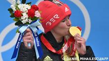 Germany's Natalie Geisenberger celebrates on the podium with her gold medal during the venue ceremony after the women's singles luge event at the Yanqing National Sliding Centre during the Beijing 2022 Winter Olympic Games in Yanqing on February 8, 2022. (Photo by Daniel MIHAILESCU / AFP)